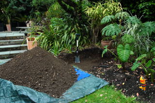 The soil is piled onto the tarpaulin.